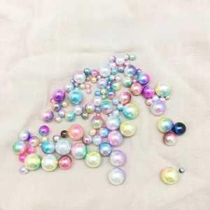 Macro detail of multi-sized holeless mermaid iridescent pearls for DIY craft projects