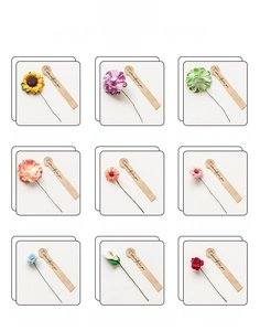 Detail view of assorted artificial paper and foam flowers with decorative kraft paper tags