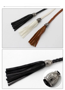 Detail of woven tassels and vintage silver sunflower metal charms in black, white, brown