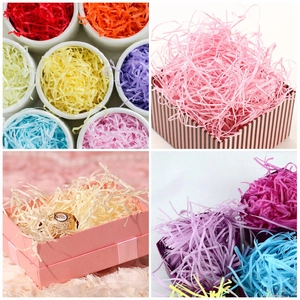 Detailed view of colorful shredded raffia paper used as filler in gift boxes and bowls