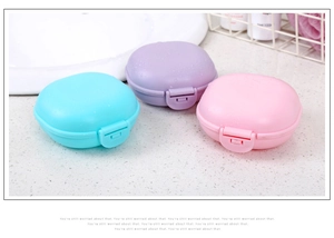 Three round plastic soap boxes in blue, purple, and pink with waterproof snap lids