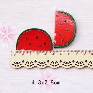 Detail view of resin watermelon pendants with metal rings and size measurements