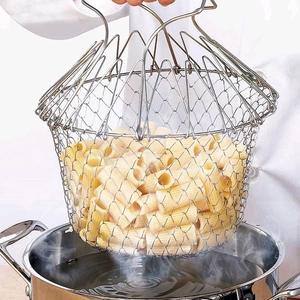 Collapsible stainless steel chef basket straining cooked pasta in a professional kitchen