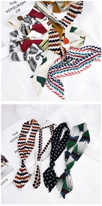 Flat lay of colorful narrow silk scarves with geometric and botanical prints on white