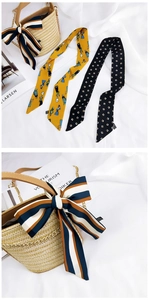 Detailed view of three assorted silk scarves with striped, portrait, and geometric patterns