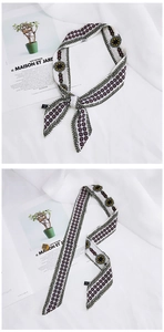 Detail of floral silk scarf tied in a bow and laid flat with vintage geometric patterns