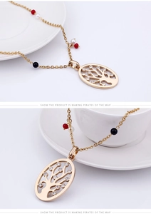 Detail of gold Tree of Life necklace featuring colorful beads and crystal accents