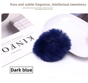 Detailed macro view of dark blue plush faux fur scrunchie with soft velvet texture