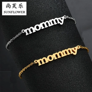 Detail view of Mommy script lettering bracelets in gold and silver stainless steel