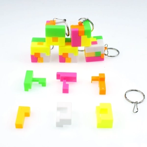 Close-up of disassembled colorful 3D puzzle cube keychain parts and assembled cubes