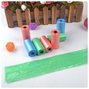 Macro shot of colorful biodegradable pet waste bags in red, blue, and green rolls