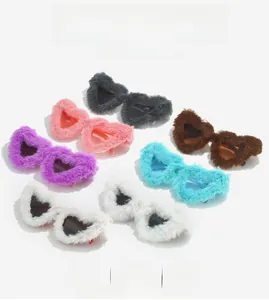 Flat lay of heart-shaped sunglasses with colorful faux fur frames in multiple vibrant colors