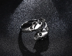 Macro shot of gothic double skull ring with detailed scale texture and silver finish