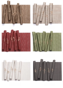 Macro view of woven PVC table mats showing multiple colors and bamboo texture detail