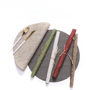 Detail of woven bamboo pattern PVC placemats in multiple colors with textured finish