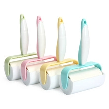 Set of four portable lint rollers in blue, pink, yellow, and green handle variations
