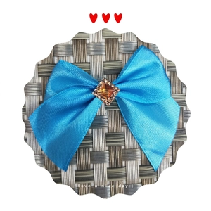 Detailed view of a blue satin bow with a square amber crystal for hair accessories