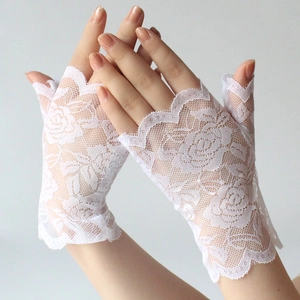 Detailed close-up of white lace fingerless gloves with elegant rose embroidery pattern