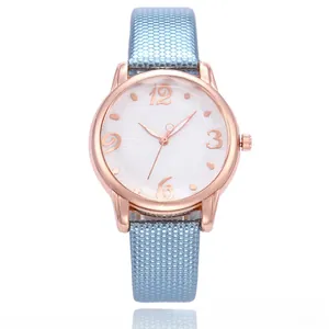 Close-up of floral dial quartz watch with rose gold case and blue diamond textured strap