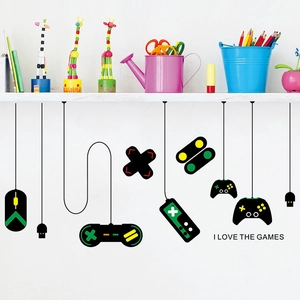 Detail of gamer wall decal featuring gamepads and 'I LOVE THE GAMES' text on white wall