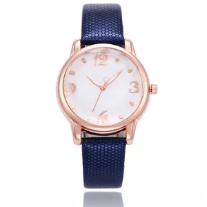 Detail of rose gold quartz watch featuring floral white dial and navy honeycomb strap
