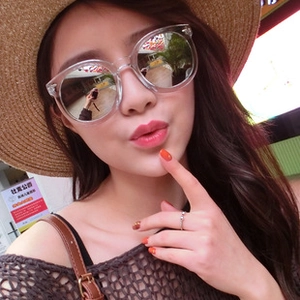 Detail of oversized silver mirror sunglasses with a transparent frame in a street style look