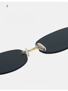 Detail of comfortable silicone nose pads and golden metal bridge on Y2K rimless sunglasses