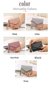 Mini envelope wallets with heart tassel charms shown in pink, purple, grey, and black colors