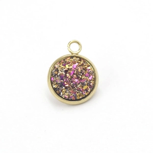 Macro shot of 8-12mm gold stainless steel round charm with glittering purple resin inlay