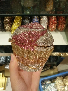 Close-up of a sparkling cupcake-shaped evening bag featuring pink and silver crystal rhinestones