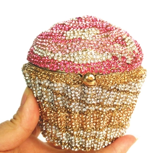 Detailed close-up of cupcake clutch bag with pink crystals and hollow metal frame