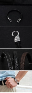 Detail of woven leather bracelet featuring a silver stainless steel snake head clasp
