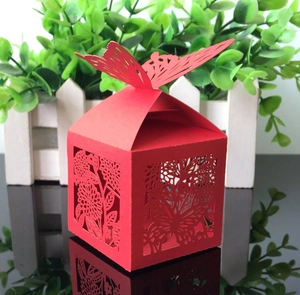 Detailed laser-cut red wedding favor box featuring an elegant butterfly top and floral patterns