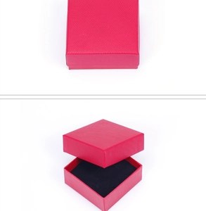 Detailed view of red woven texture jewelry box with black interior lining in square shape