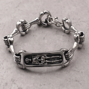 Men's retro silver punk skeleton steel bracelet with skull relief on grey stone background