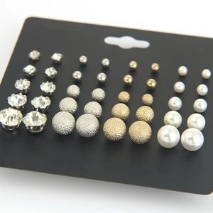 Set of 18 pairs of pearl, rhinestone, and matte stud earrings on a display card