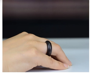 Classic dark wood ring shown on finger with minimalist design for a natural aesthetic