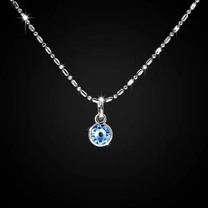 Detailed close-up of a silver-tone necklace with a brilliant blue gemstone pendant