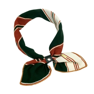 Linen silk scarf with red, green and white stripes secured by a black leather buckle