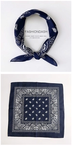Macro detail of navy blue paisley cotton scarf showing soft texture and classic pattern
