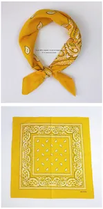 Detailed view of yellow paisley cotton square scarf with 100% cotton material label