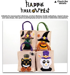 Detail showing four assorted linen Halloween candy bags with witch and pumpkin appliques