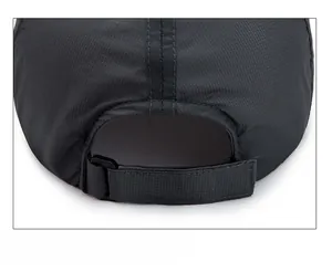 Detail of black ripstop baseball cap showing the adjustable velcro back closure mechanism