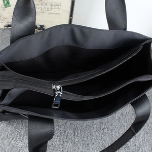 Men's black nylon briefcase featuring a multi-compartment design with three metal zippers