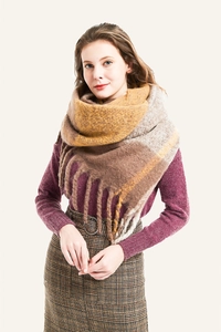 Close-up of thick yellow and brown checkered knit scarf with soft tassel details