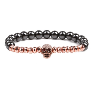 Bracelet perlé en hématite avec crâne or rose et yeux en cristal rouge pour hommes
