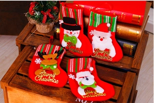 Detailed view of 3D Santa, Snowman, Reindeer, and Bear Christmas stockings on a wooden crate
