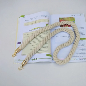 Detail of beige cotton rope shoulder strap with gold metal swivel lobster clasps
