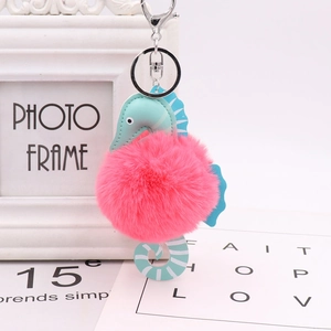 Detail of pink fluffy seahorse keychain with turquoise PU leather and silver metal ring