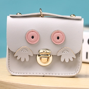 Detail of light gray owl coin purse showing premium PU leather texture and gold hardware